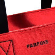 a close up of a red tie on a red blanket 